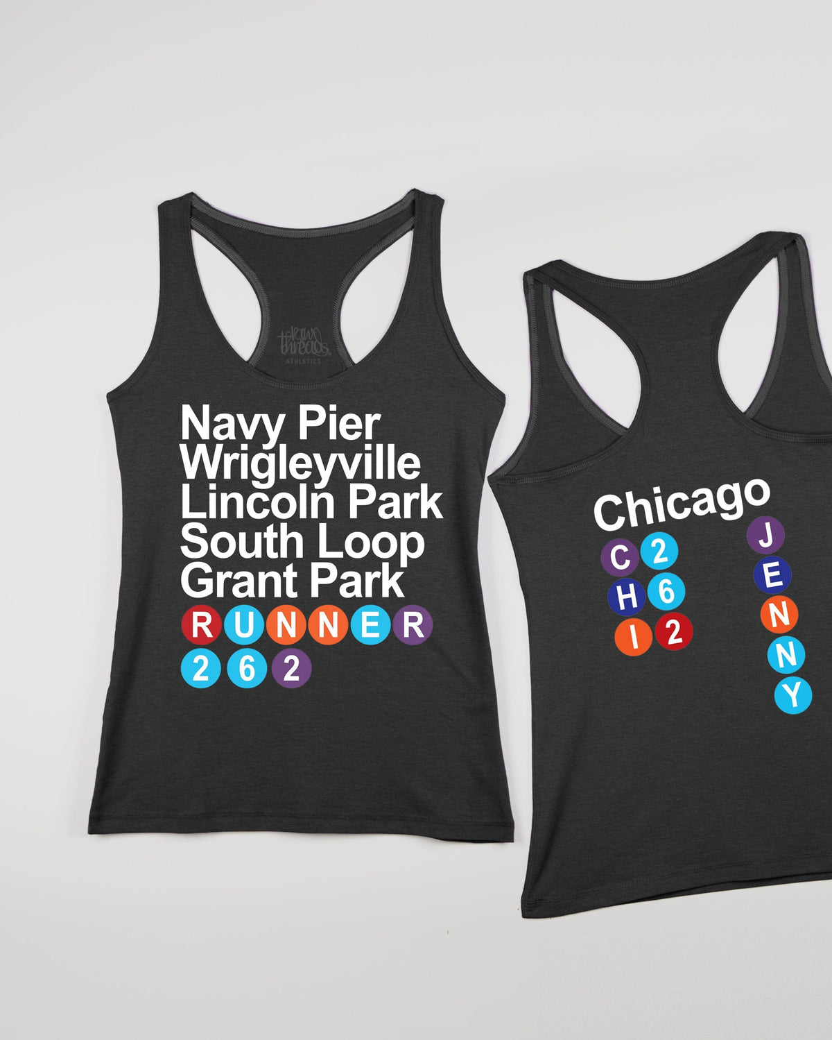 Two black tank tops with white and colorful text displaying Chicago landmarks and areas such as Navy Pier, Wrigleyville, Lincoln Park, South Loop, and Grant Park.