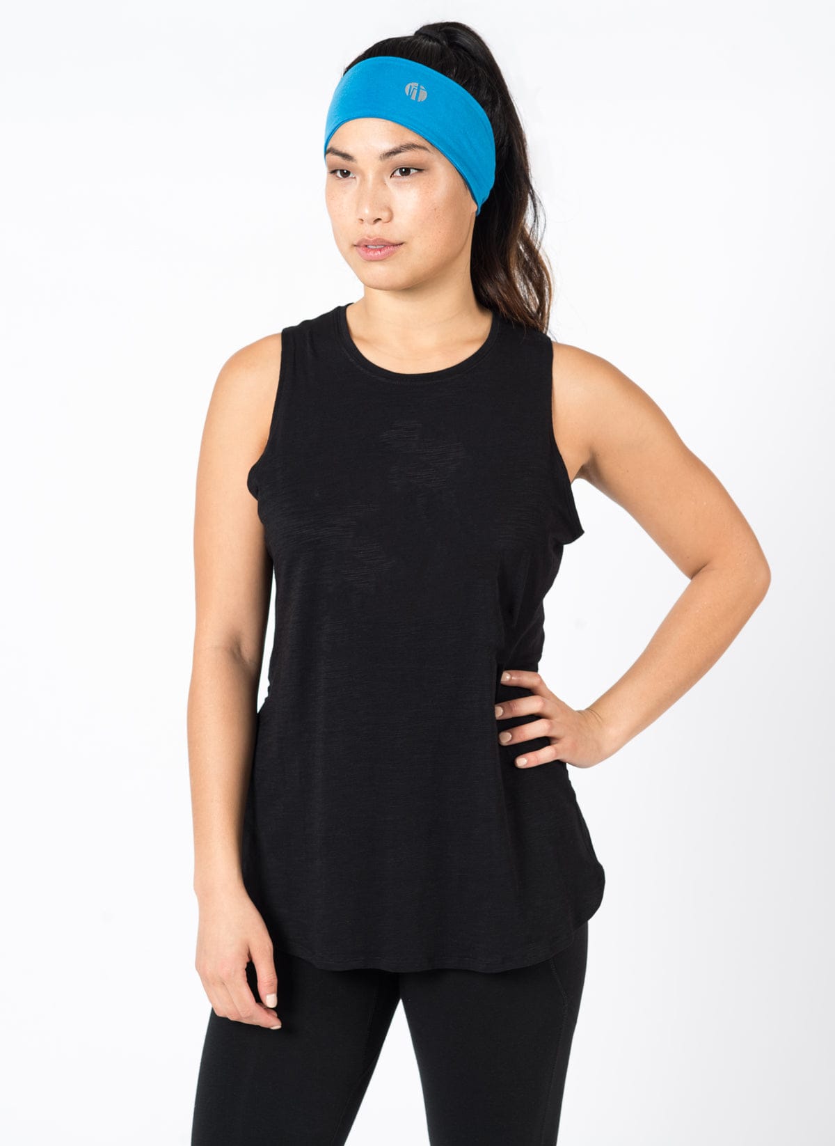 Woman wearing a black sleeveless top and black leggings with a blue headband  showcasing Raw Threads signature rayon from bamboo fabrics: 66% rayon from bamboo, 28% cotton, 6% spandex