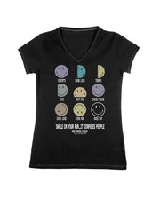 A black women's V-neck t-shirt featuring a graphic of nine smiley faces in various colors, each labeled with a training term like 'Sprints', 'Carb Load', 'Tempo', 'Yoga', 'Rest Day', 'Cross Train', 'Long Run', and 'Race Day'. Below the smileys, the text reads 'SMILE ON YOUR RUN…it confuses people. Raw Threads x Smiley.