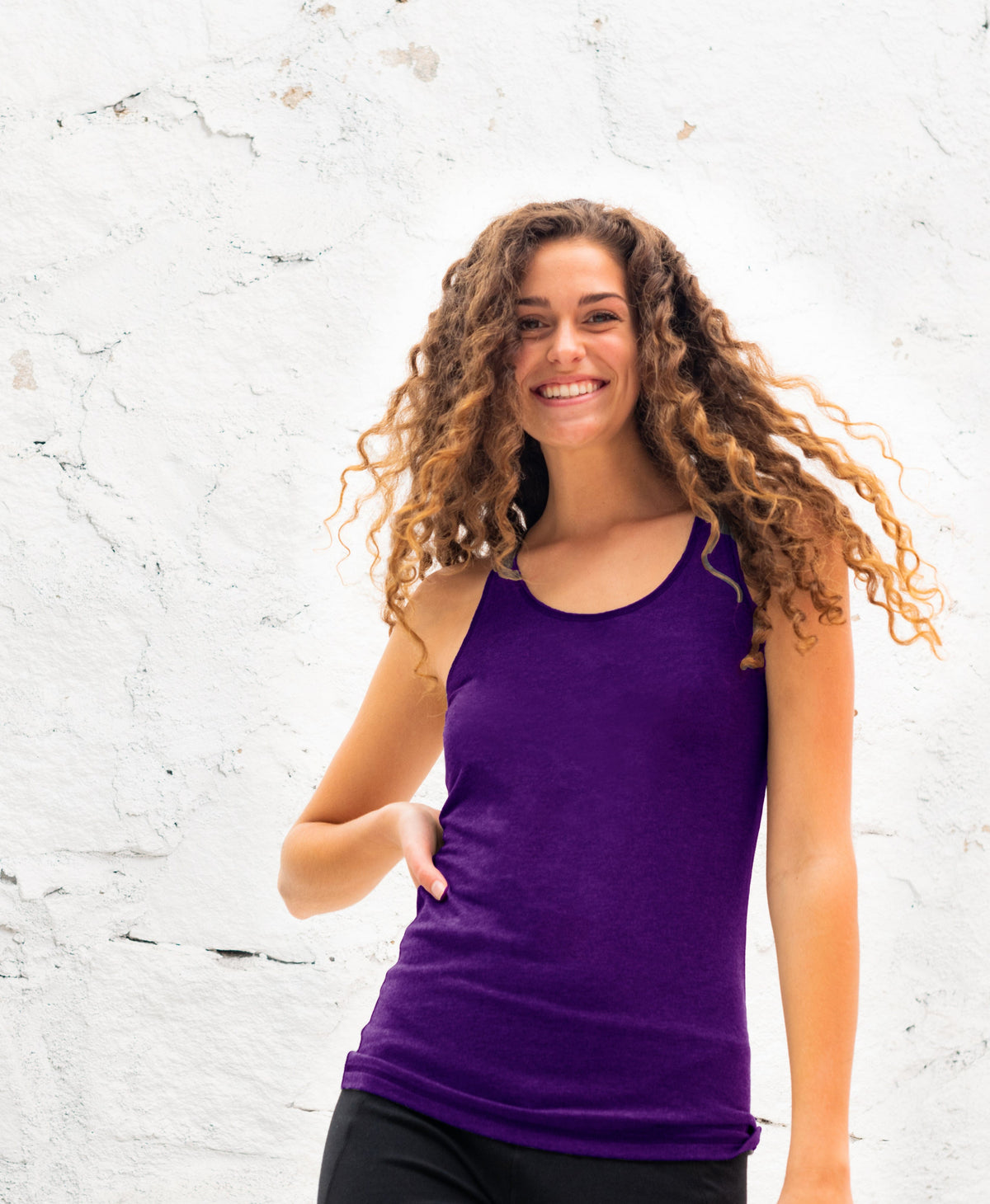 A deep purple racerback tank with a fitted silhouette, flat athletic seams and a flattering scoop neckline.