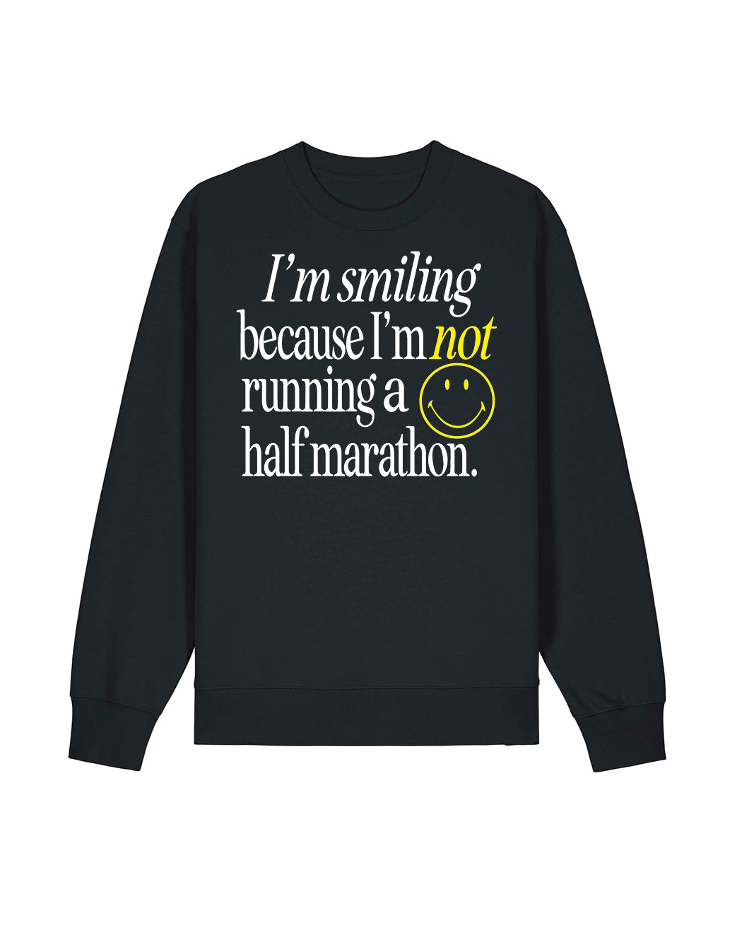 An oversized gender-neutral black crewneck sweatshirt with a graphic text print on the front reading 'I'm smiling because I'm not running a half marathon.' in white and yellow, accompanied by a yellow smiley face and the Raw Threads X Smiley logo.