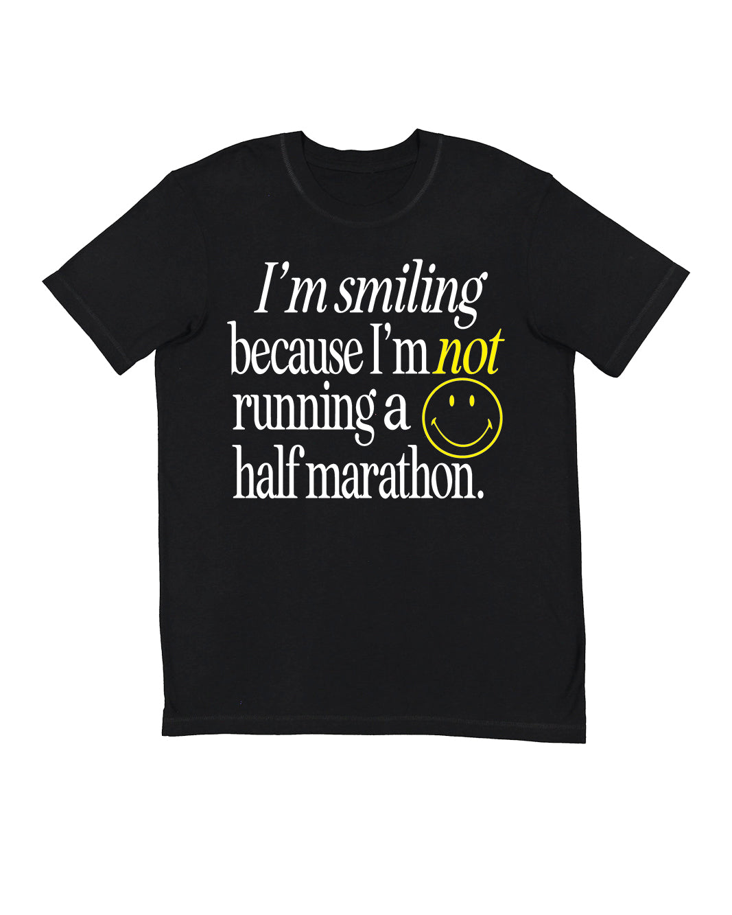 A gender-neutral black running crewneck t-shirt with a graphic text print on the front reading 'I'm smiling because I'm not running a half marathon.' in white and yellow, accompanied by a yellow smiley face and the Raw Threads X Smiley logo.